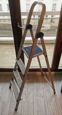 a ladder that is leaning against a window in a room
