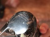 a person holding a spoon in their hand with a spoon inside of it