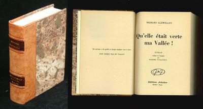 two books that are open on a black surface