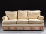 an image of a couch with pillows on it in a dark room