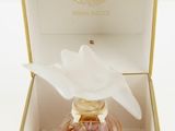 a bottle of perfume in a box with a flower on it