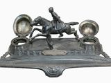 a statue of a man riding a horse with three lamps