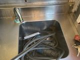 a sink that has a bunch of hoses in it