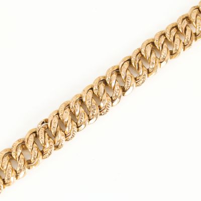 a close up of a gold chain on a white background