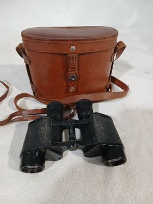 an old pair of binoculars sitting on top of a white cloth