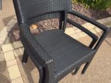 a black chair that is sitting on a patio
