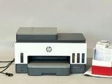 a printer that is sitting on a table next to a box