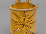an image of a yellow vase with a star design on it