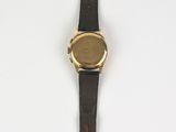 a close up of a watch on a white surface with a white background