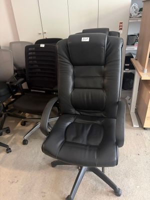 a black office chair in the middle of a room