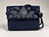 a close up of a blue purse with a chain strap
