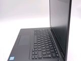a black laptop with a black keyboard on a white surface