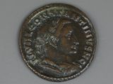 an old coin with a man ' s face on it on a table