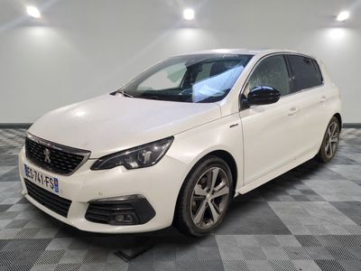 a white car is parked in a room with a checkered floor