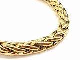 a close up of a gold bracelet on a white background
