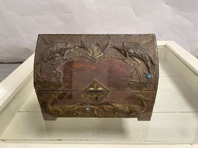 a small wooden box with a design on it