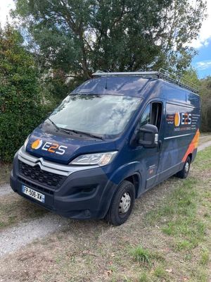the van is parked on the side of the road in the grass