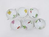 six white bowls with different designs on them on a white surface