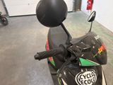 a motorcycle parked in a garage with a helmet on the seat