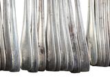 a lot of silver spoons that are lined up together