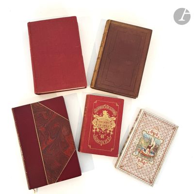 several books are lined up on a white surface with a white background