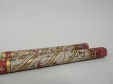 an image of a red and gold pen sitting on top of a white table
