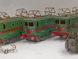 several toy trains are lined up in a row on a white surface