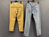 deux paires de jeans jaunes et bleus accrochées au mur