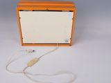 a small orange box with a cord attached to it