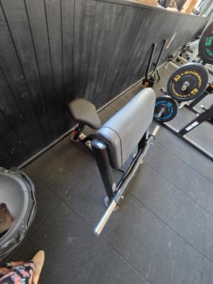 a person sitting on a bench in a gym