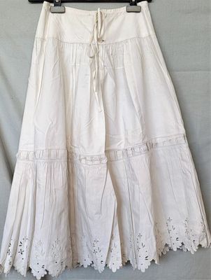 the skirt is white and has crochets on it