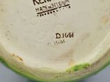a close up of a bowl with a bird on it