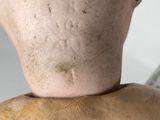 a close up of a doll with a knife in it ' s hand