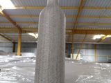 a bottle of wine sitting on a table in a warehouse