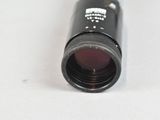a close up of a black bottle with a red lid