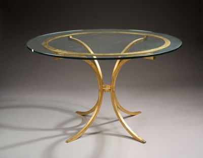 an image of a glass table with gold metal legs and a glass top