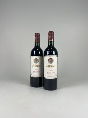 two bottles of red wine sitting next to each other on a table