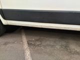 a white van parked in a parking lot next to a building