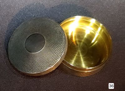 a small metal box with a lid on a table