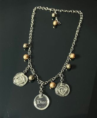 necklace with coins and charms on a black surface