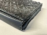 a black purse that has a lot of studding on it
