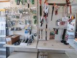 many tools hanging on the wall in the shop