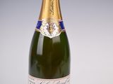 an image of a bottle of champagne sitting on a table