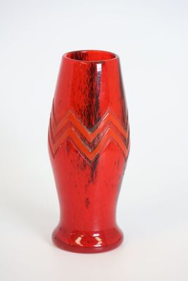 a red vase with a chevroned design on it
