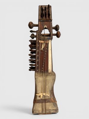 an old musical instrument that is sitting on a white surface