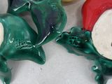 three ceramic figurines of a frog and a banana