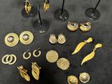 several pieces of gold jewelry are displayed on a black surface
