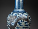 a blue and white vase with a dragon on it