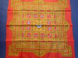 une image représentant une nappe rouge et dorée ornée d'un motif