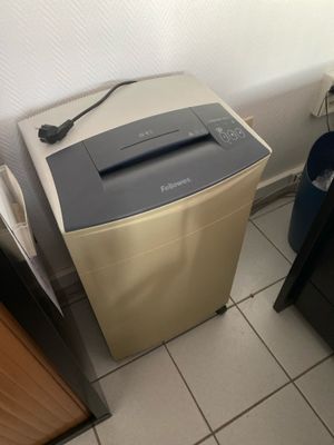 an image of a paper shredder in the corner of a room